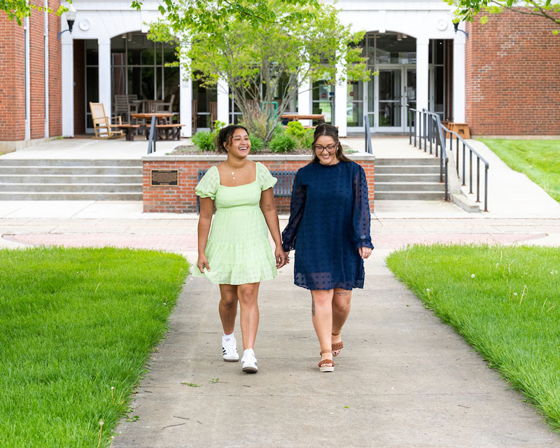 Two students smile while walking outside at Ohio University’s Zanesville campus.