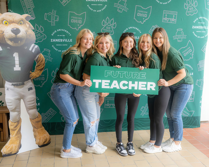 Several OHIO Zanesville students pose with a “future teacher” sign.