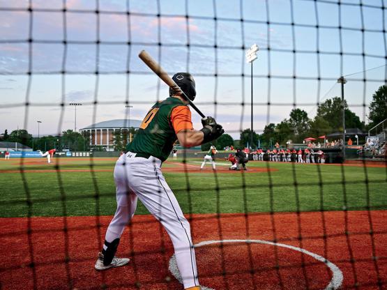A player on the Southeastern Copperheads baseball team is up to bat on the field