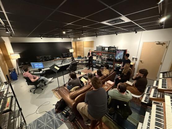 Ohio University students sit in a live recording studio with a professional for a hands-on experience